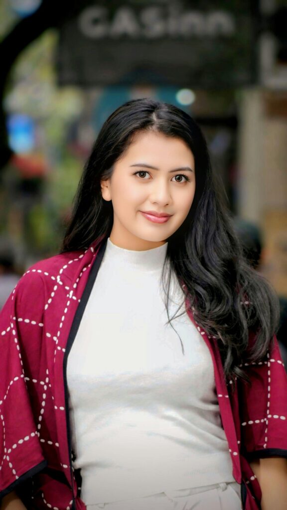 Portrait of a woman in Bandung, Indonesia, wearing a stylish red and white outfit.